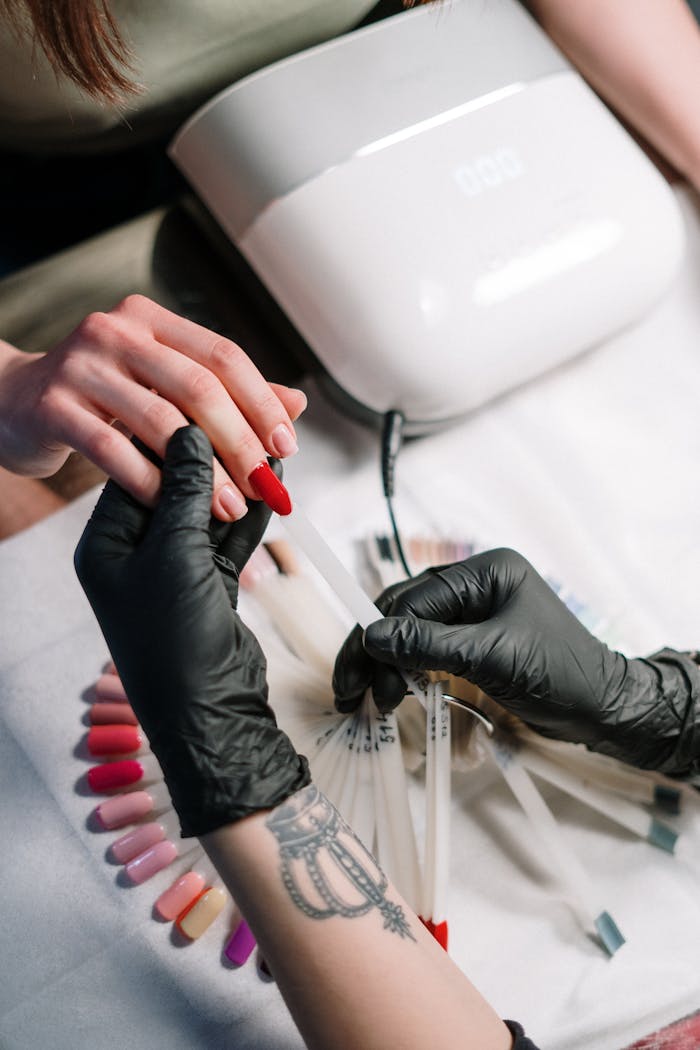 Close-up of a manicure session with nail polish color selection in a beauty salon.